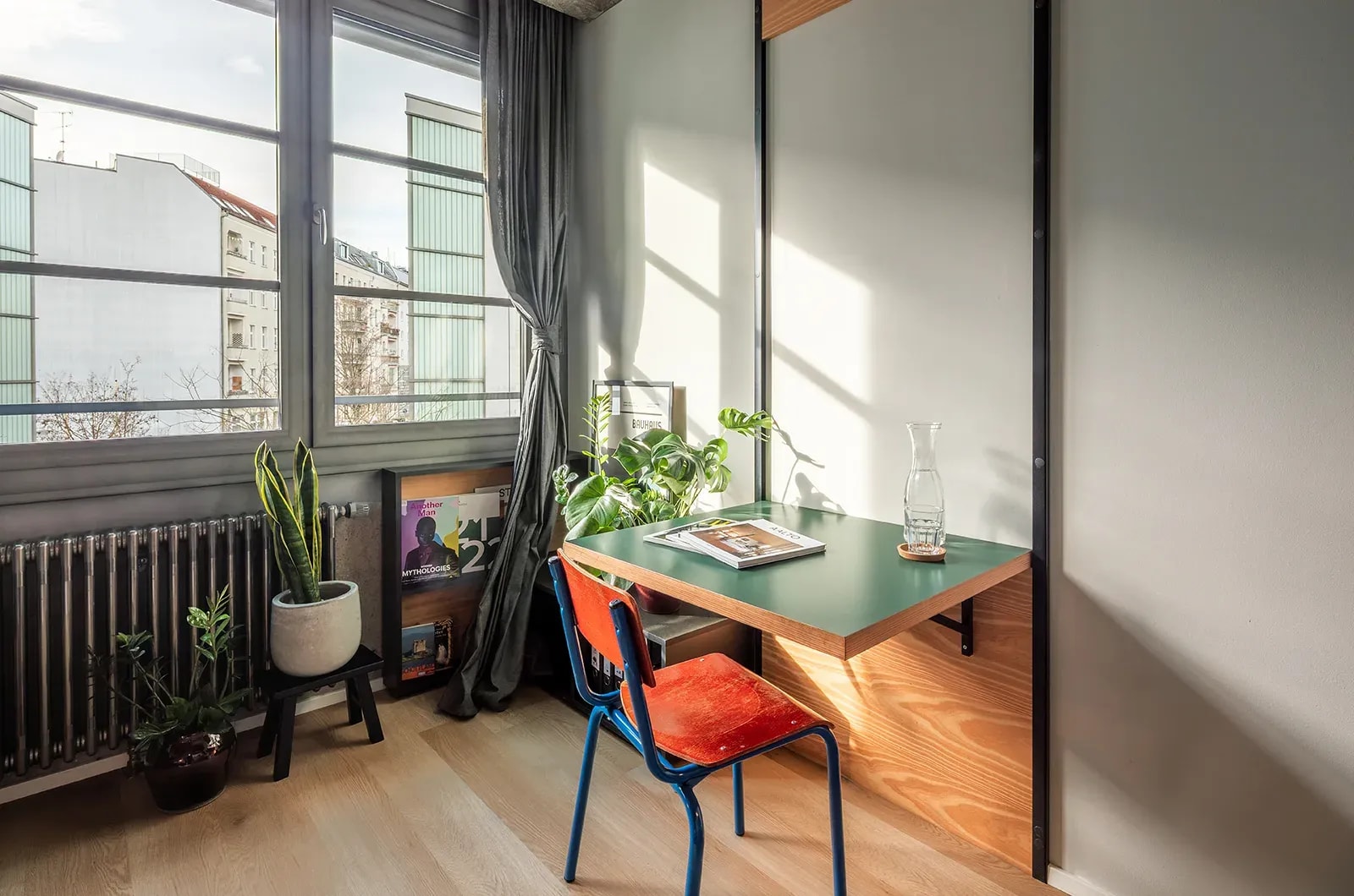 Styled dining area with fold-out table in a Classic Room at Neon Wood Berlin Frankfurter Tor showing decorated space and personalization example